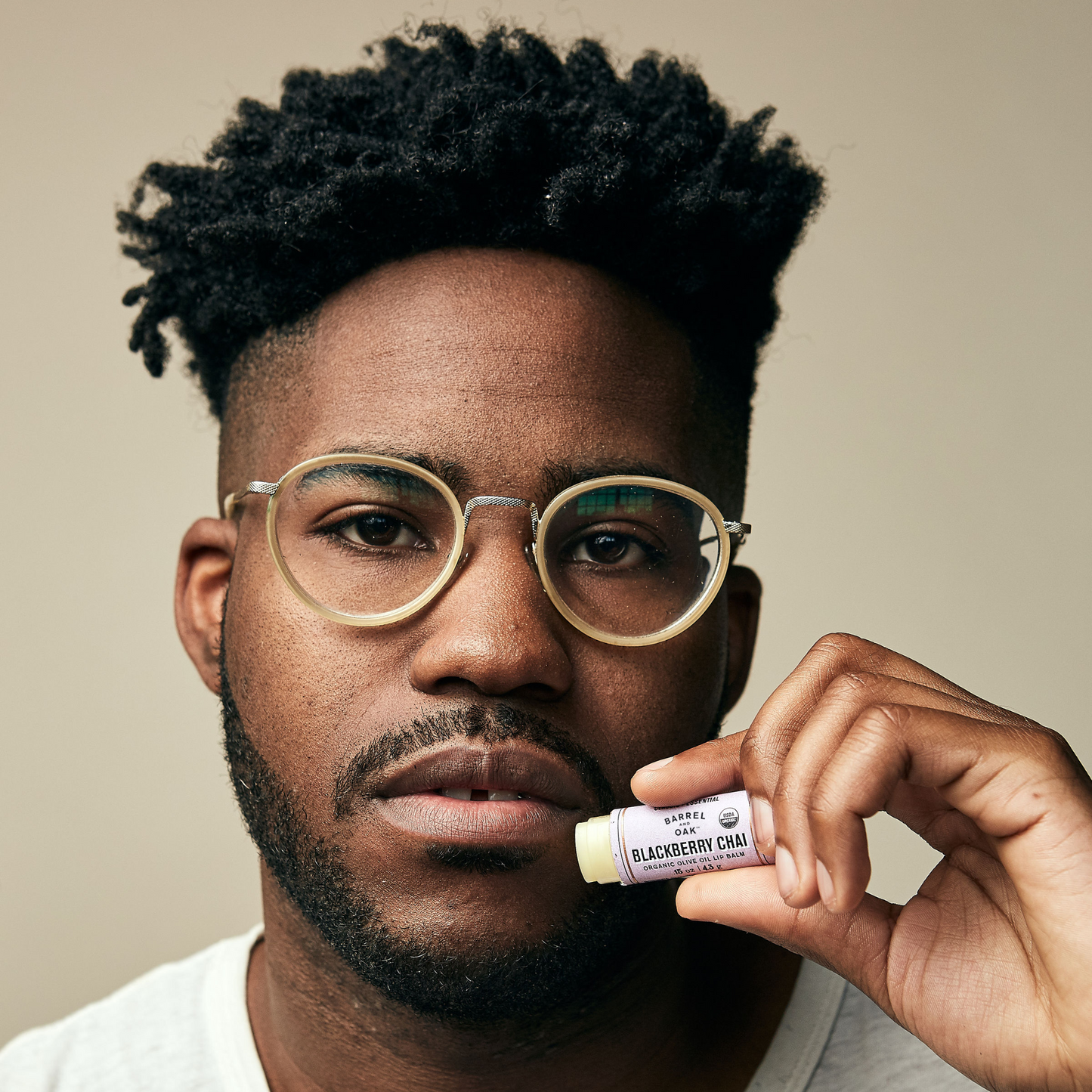 Model holding Olive Oil Lip Balm - Blackberry Chai to their lips