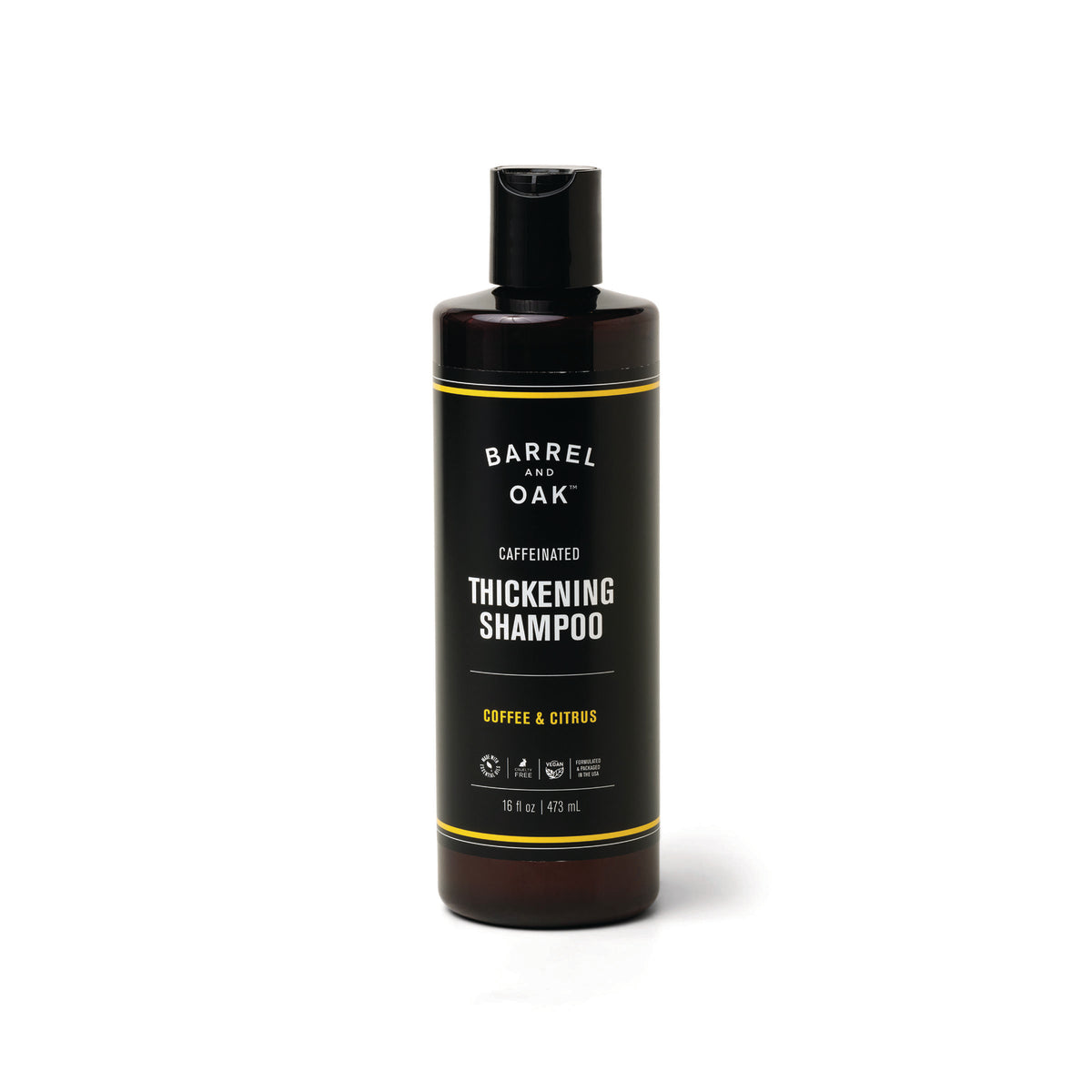 A tall, dark bottle of Caffeinated Thickening Shampoo - Coffee & Citrus 16 oz. sits against a white background. Infused with organic coffee extract and biotin, it promotes thicker-looking hair and features a black flip-top cap.