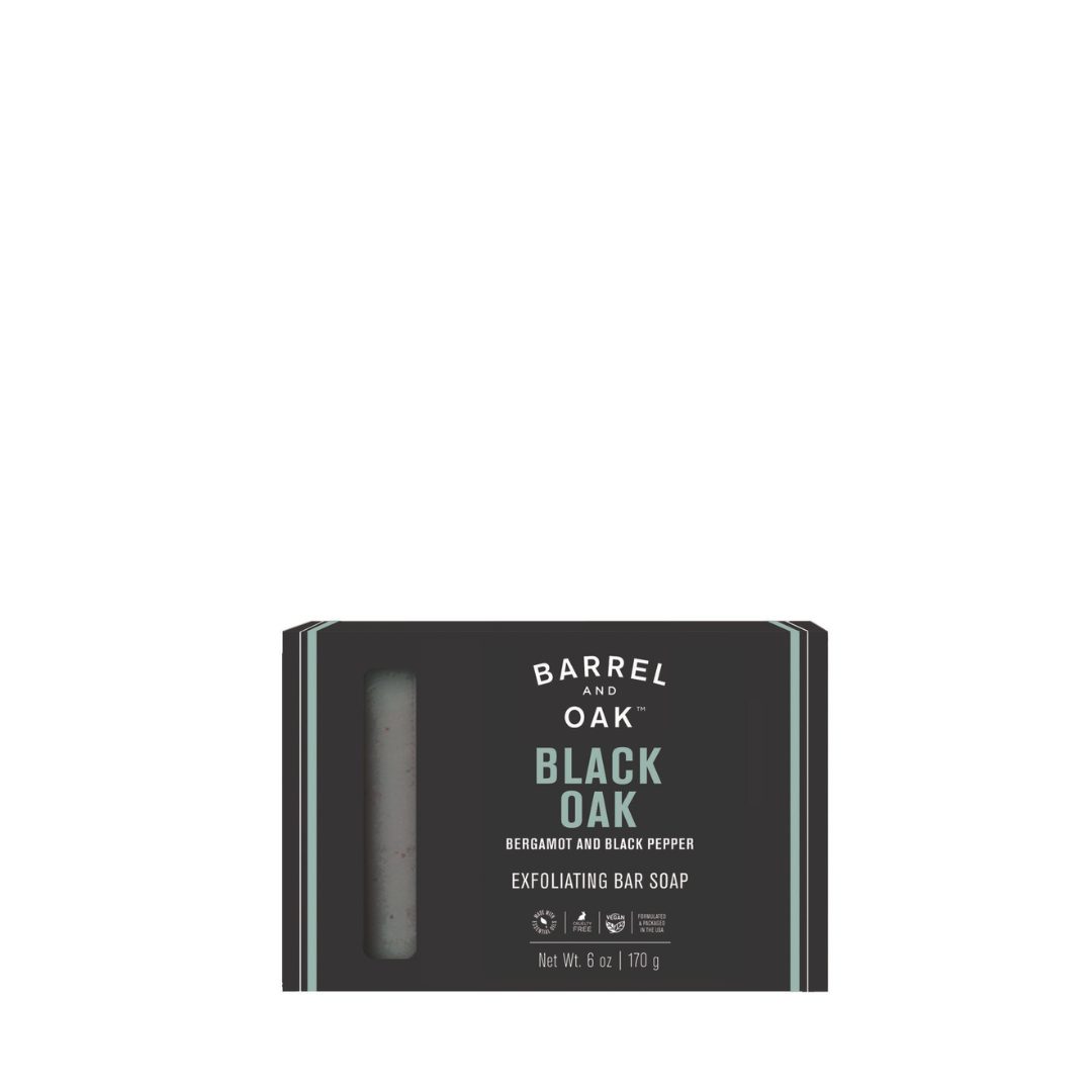 Exfoliating Soap Bar - Black Oak 6 oz, in black packaging with teal accents and a window to view the soap. Infused with bergamot, black pepper, charcoal powder, and made with sustainable palm oil.