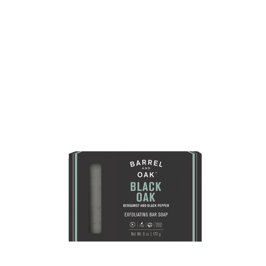 Exfoliating Soap Bar - Black Oak 6 oz, in black packaging with teal accents and a window to view the soap. Infused with bergamot, black pepper, charcoal powder, and made with sustainable palm oil.