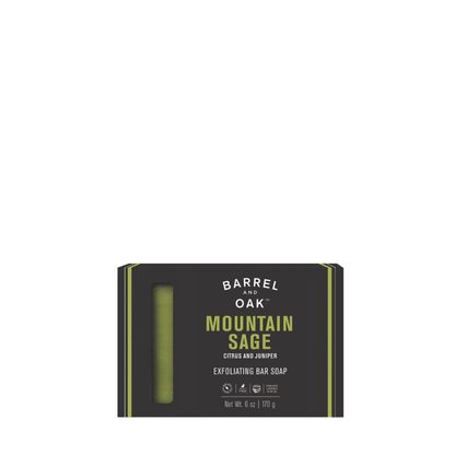A black box of Barrel and Oak Exfoliating Soap Bar - Mountain Sage 6 oz. features citrus, juniper, and kaolin clay with a green bar visible through a window. Packaging shows product details and weight (6 oz/170 g).