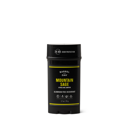 A black stick of Aluminum Free Deodorant - Mountain Sage 2.7 oz. stands upright on a white background. Infused with essential oils, it offers 24-hour odor protection in cruelty-free packaging, featuring notes of citrus and juniper.