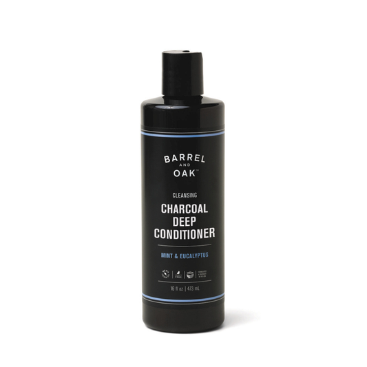 A black bottle of Charcoal Deep Conditioner - Mint & Eucalyptus 16 oz features white text and a flip-top cap, providing deep conditioning with argan oil, mint, and eucalyptus for revitalized hair.
