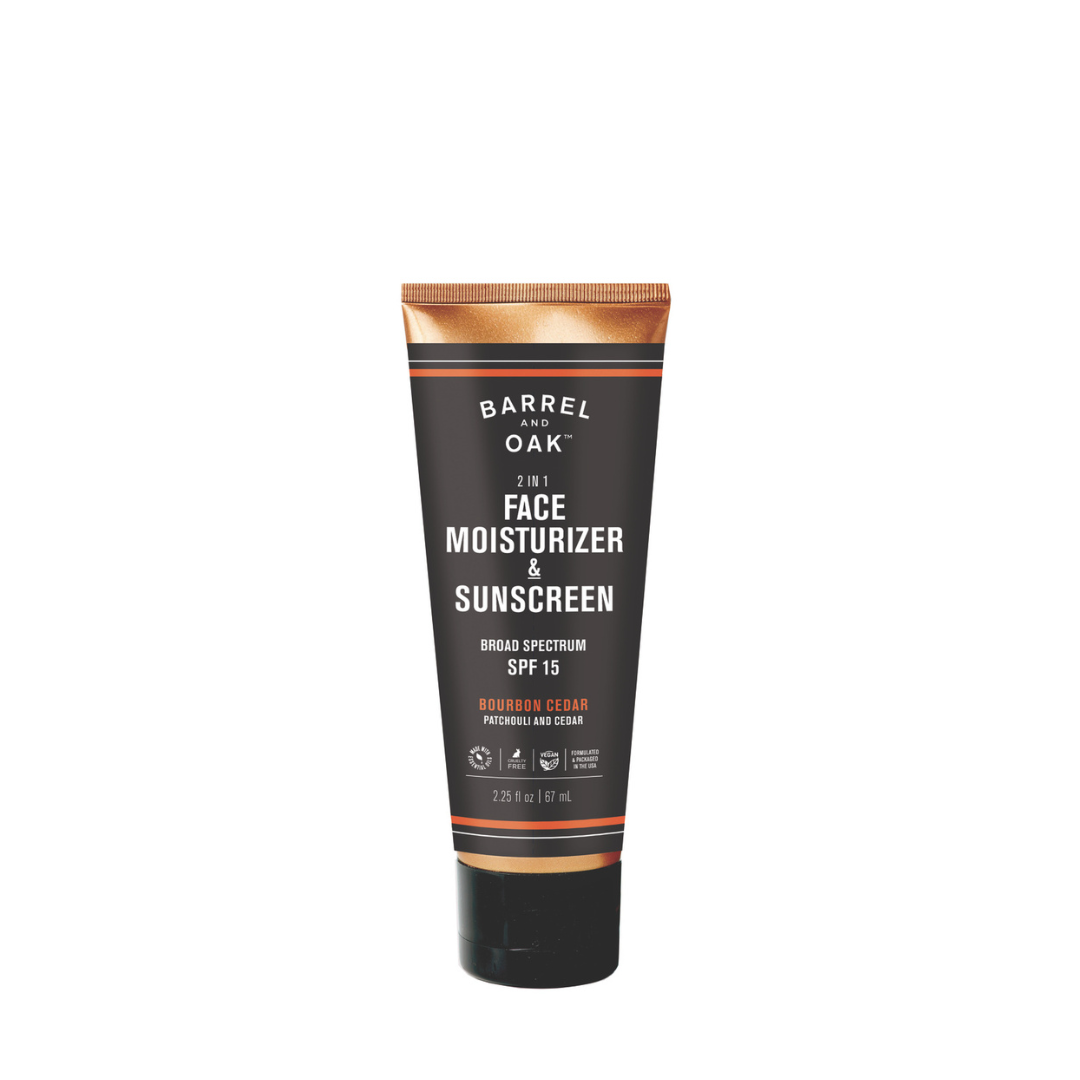 A 2.25 fl oz. tube of SPF 15 Moisturizer in Bourbon Cedar scent stands upright on a white background; the black packaging features brown and orange accents.