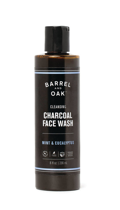 An 8 oz. bottle of Cleansing Charcoal Face Wash - Mint & Eucalyptus features a refreshing scent, with a dark design, black flip cap, and white product details.